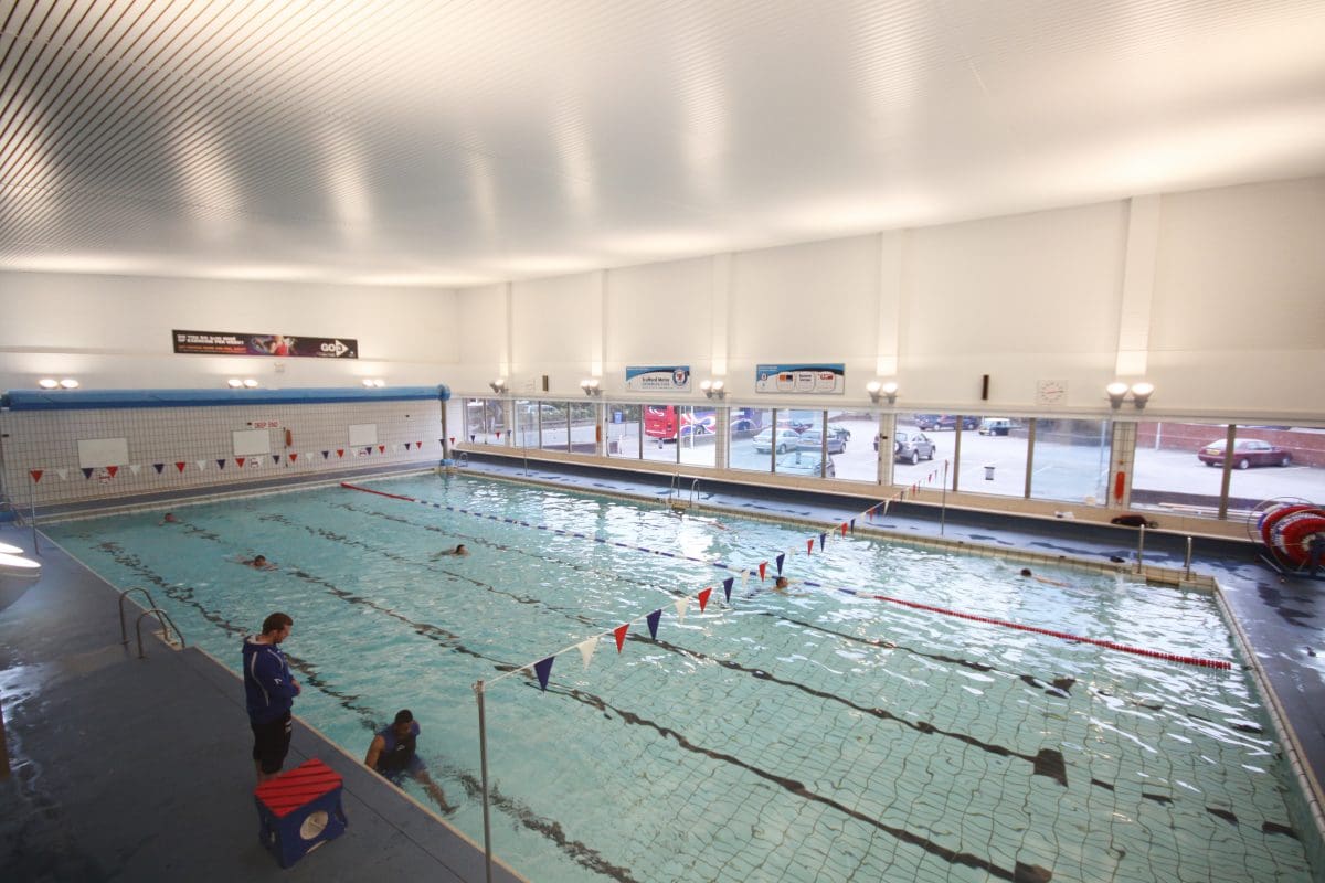 a group of people swimming in an indoor pool