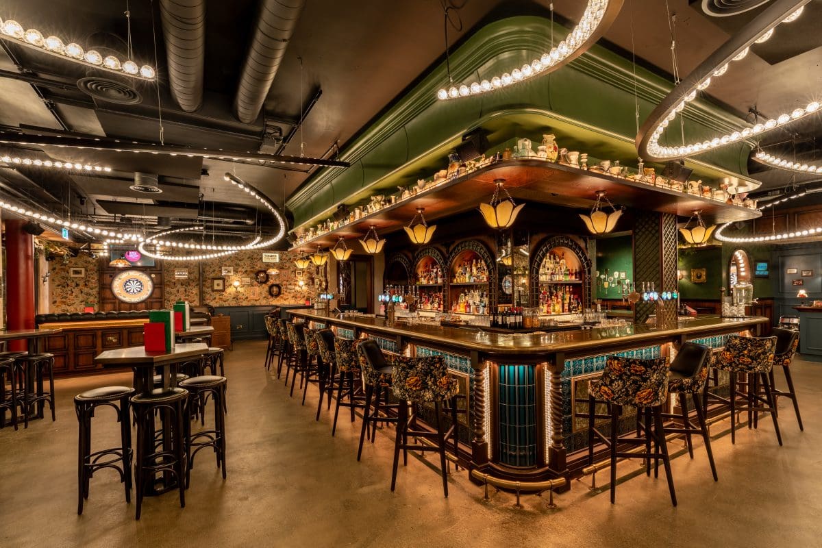 vibrant bar area with seating and dart board